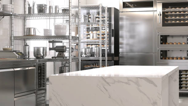 istock Empty clean white marble top island table in commercial, professional bakery kitchen with stainless steel convection, deck oven, freezer, refrigerator, shelf, cabinet, equipment 1492460521