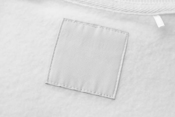 istock Blank white laundry care clothes label on fabric texture background 1492463402