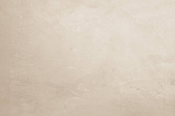 istock Colour old concrete wall texture background. Close Up retro plain cream color cement wall background texture. Design paper vintage parchment element show or advertise or promote product on display. 1492464476