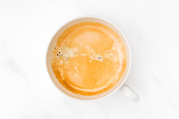 istock Cup of coffee latte cappuccino top view on marble table 1492464829