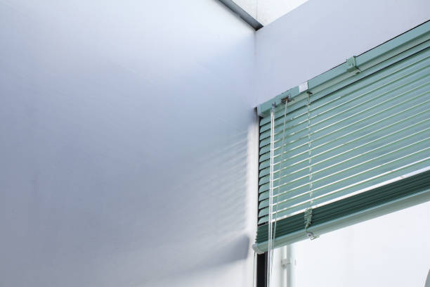 istock Aluminum window rolling blind. White plastic window with blinds close-up. Interior design. 1492465221