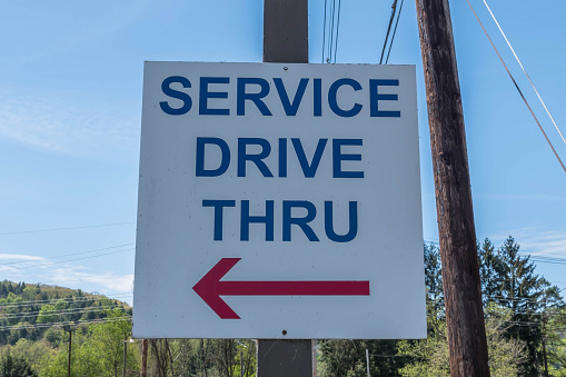 A sign at a car dealership for service drive thru in Starbrick, Pennsylvania, USA on a sunny spring day