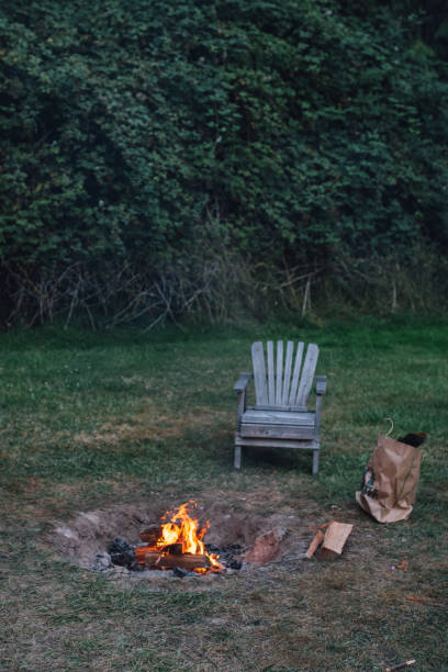 istock Campfire and Adirondack chair on grass 1492469419
