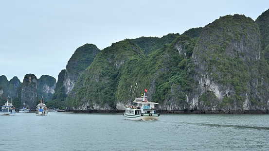 Ha Long Bay is located in Ha Long City, Quang Ning Province, Vietnam. It is a typical limestone karst landform bay. The whole bay has about 120 kilometers of coastline, a total area of about 1553 square kilometers, and about 2000 islets.\nAbout 434 square kilometers of the central area (containing 775 islets) is a World Natural Heritage Site. The scenery is beautiful and charming.\nIt is a national scenic spot in Vietnam. Countless foreign tourists come here for sightseeing.\nHa Long Bay has a large yacht marina, and there are many yachts cruising around the scenic area every day.