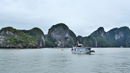 Ha Long Bay is located in Ha Long City, Quang Ning Province, Vietnam. It is a typical limestone karst landform bay. The whole bay has about 120 kilometers of coastline, a total area of about 1553 square kilometers, and about 2000 islets.\nAbout 434 square kilometers of the central area (containing 775 islets) is a World Natural Heritage Site. The scenery is beautiful and charming.\nIt is a national scenic spot in Vietnam. Countless foreign tourists come here for sightseeing.\nHa Long Bay has a large yacht marina, and there are many yachts cruising around the scenic area every day.