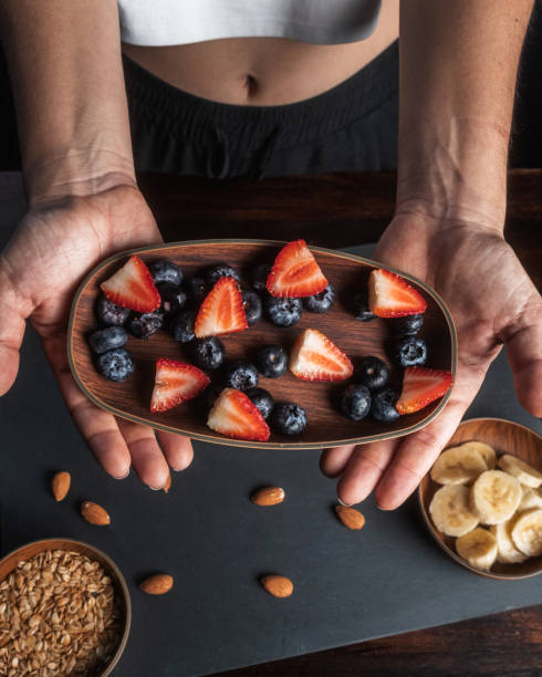 istock Woman shows ingredients for a healthy fruit snack in her home kitchen 1492473888