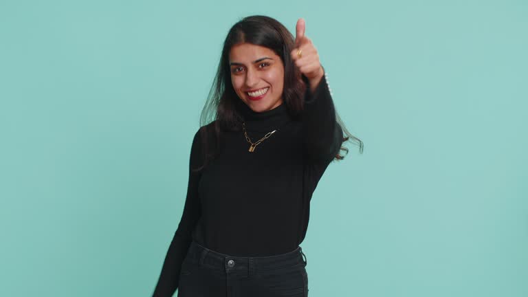 Indian woman smiling excitedly, pointing to camera, choosing lucky happy winner, indicating, hey you