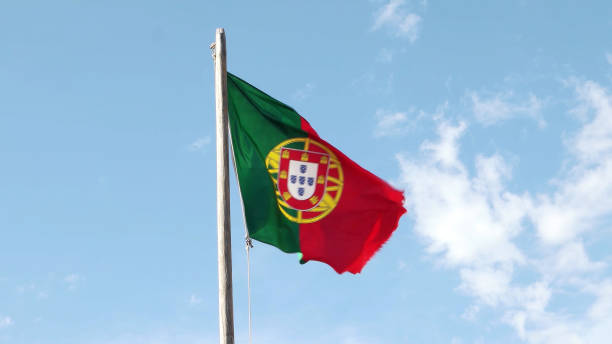 Portugal Flag waving in the wind against a clear sky.