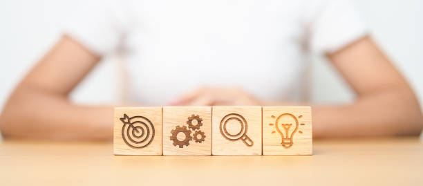 istock dartboard, Gear, magnifying and Lightbulb icon block on table. business planning process, goal, strategy, target, mission, action, research, teamwork and idea concept 1492483439