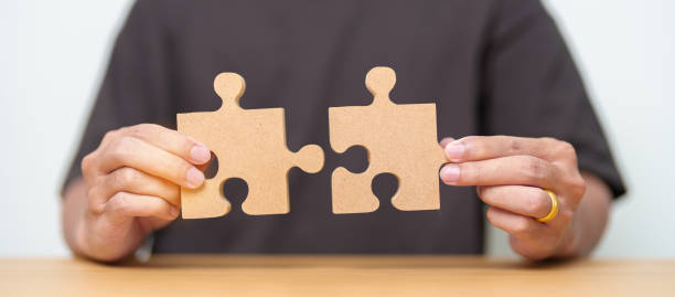 istock Hand connecting couple puzzle piece. Business Solving, mission, challenge, success, goals, target and strategy concepts 1492483657