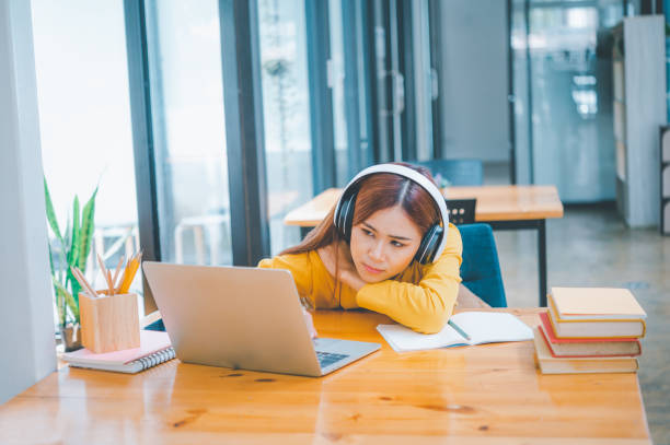 istock Female students are bored and sleepy during online classes while sitting online for long hours. 1492485424