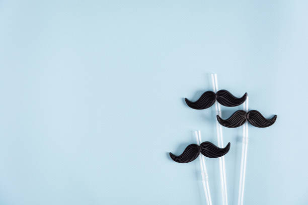 istock Curly mustaches on colorful background. Fake mustache. Top view 1492491136