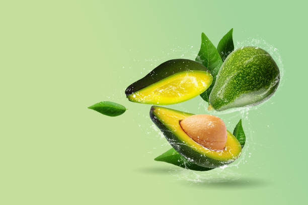 istock Green ripe avocado on a green background and Water splashing 1492498853