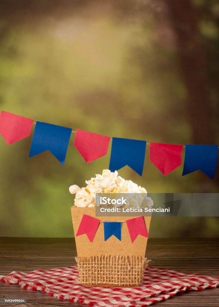 Popcorn in a Festive Setting with Hanging Banners (Brazilian Festa Junina) Festa Junina Stock Photo