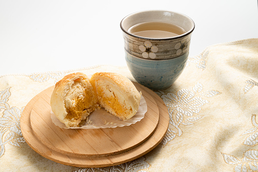Orange muffin with tea on a rustic wooden kitchen table, on a vintage tray, overhead flat lay shot with copy space