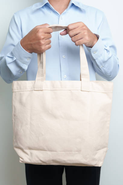 istock man with Eco Shopping tote bag with Copy space for text. Environmental Protection, Zero waste, Reusable, Say No Plastic, Sustainability, Eco Friendly, World Environment day and Earth day concept 1492500547