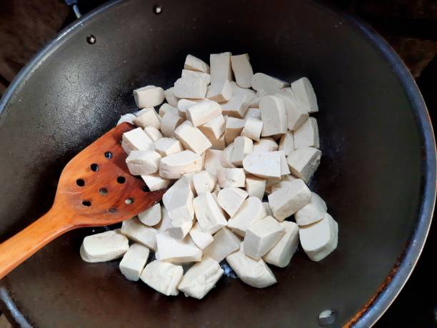 istock Frying Tofu in cooking pan - food preparation. 1492500668
