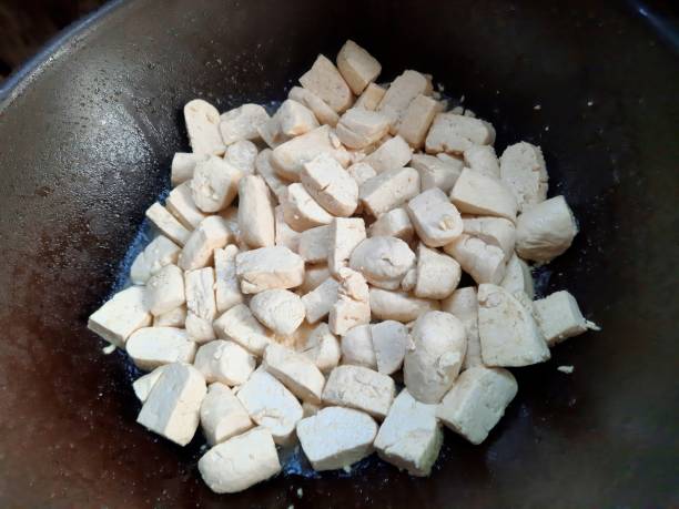 istock Frying Tofu in cooking pan - food preparation. 1492500670