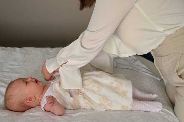istock Putting on clothes for christening 1492501865