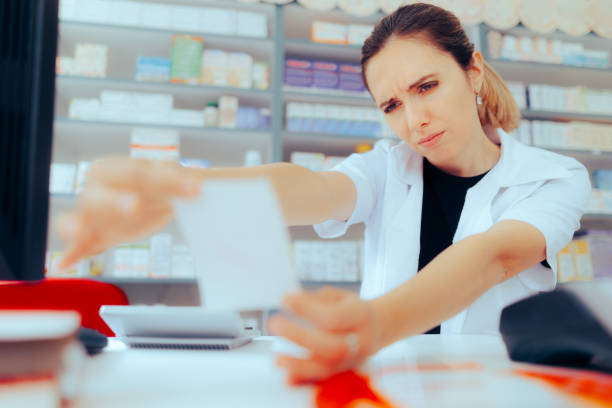 istock Pharmacist Having Problems Reading Doctor Handwriting on a Prescription 1492503969