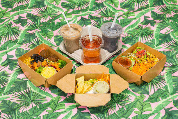 Flat lay shot of vegan food varieties, smoothies and drinks on a picnic blanket.