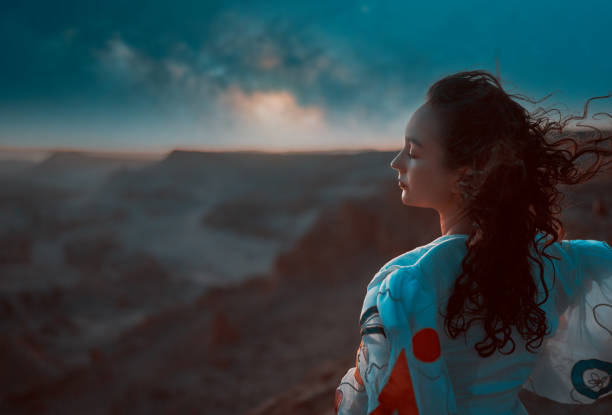 portrait woman standing at night in the Valley of the Moon in San Pedro de Atacama stock photo