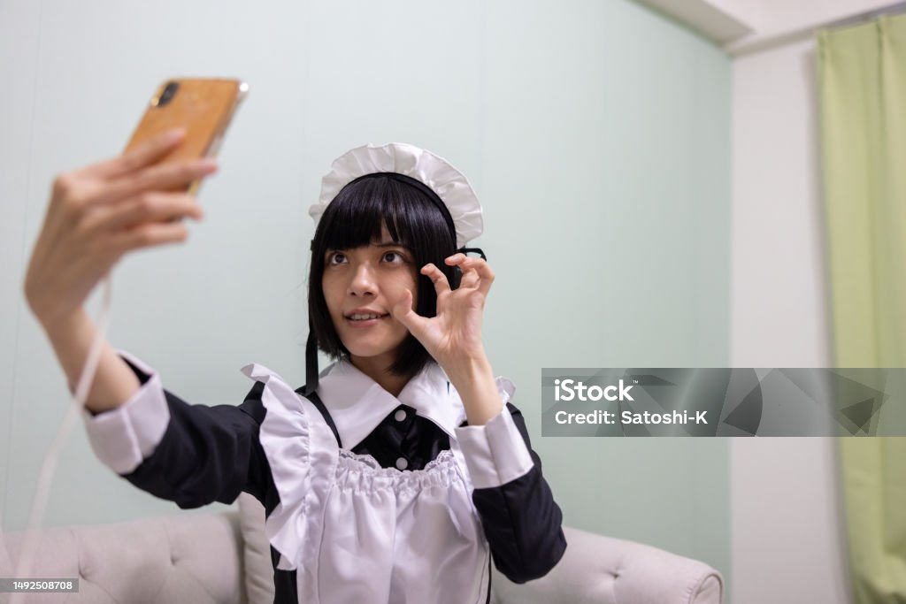 Cosplayer In House Female Cosplayer Live Streaming At Home Sitting On Sofa Stock Photo ...