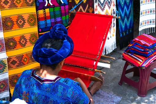 Santa Catarina Palopó, Solalá, Guatemala - October 06 2019: The Mayan woman is working with her waist loom in Guatemala.