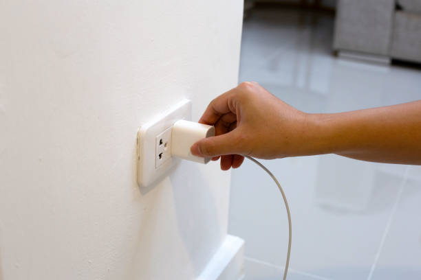 istock Hand insert a plug of the phone charger into socket. 1492513797
