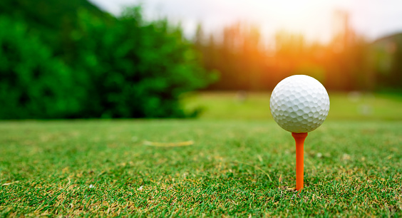 Close up golf ball on green grass field. sport golf club
