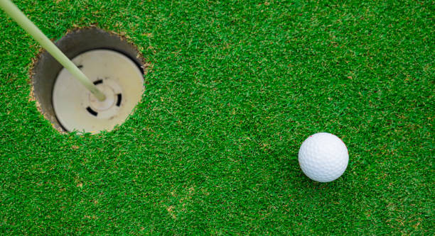 istock Close up golf ball on green grass field 1492518049