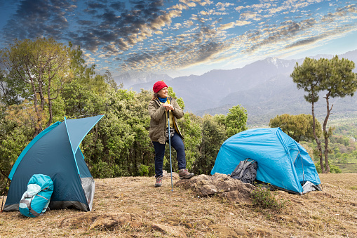 Senior woman is camping in mountain. Active retirement.