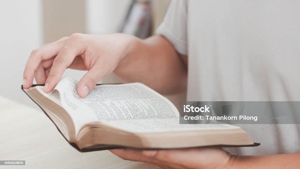 Believers are reading the Holy Bible every day and every time in a private room. The idea of studying more about God through the Bible. Adult Stock Photo