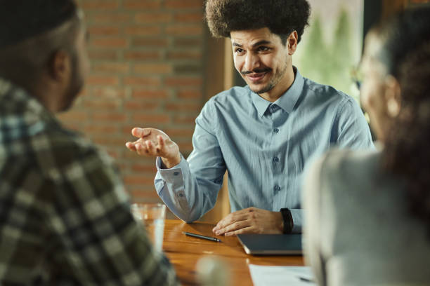 istock Smiling agent talking to his clients on a meeting in the office. 1492531767