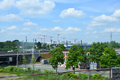 Brussels, Belgium - May 20, 2023: view through a passenger window moving train on the manufacturing Brussels district