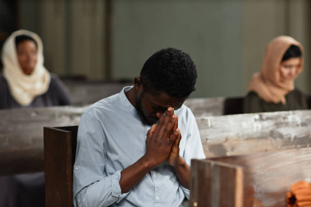 istock African American man praying in church 1492532828