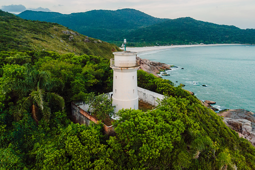 Aerial view of coastline with lighthouse and ocean on Santa Catarina island, Brazil