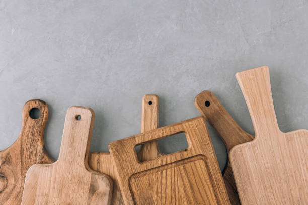 istock Chopping boards. Various wooden cutting boards on gray stone background 1492534428