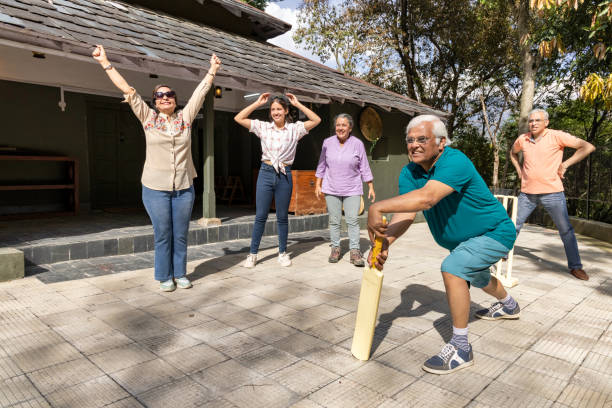 istock Family members playing cricket in the back yard. 1492535609