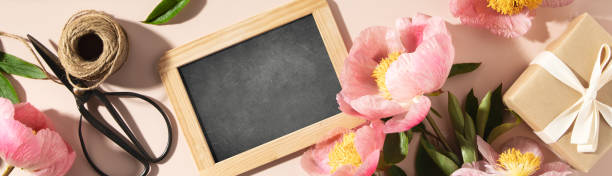 istock vintage chalk board and spring peony flowers top view 1492535849