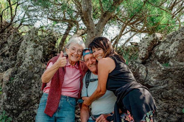 istock Cheerful group of senior people hugging looking at camera while enjoying a mountain hike in countryside appreciating leisure and freedom, retired seniors and healthy lifestyle concept 1492538455