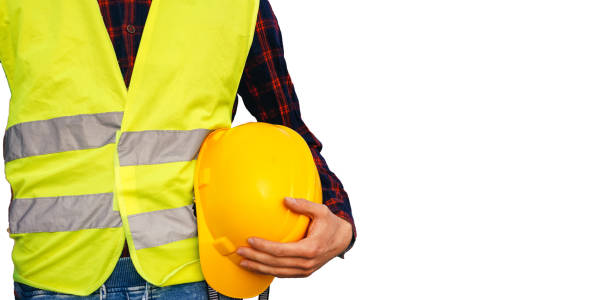 istock Construction worker holding yellow helmet. Building worker wearing fluorescent waistcoat. Isolated. 1492539145