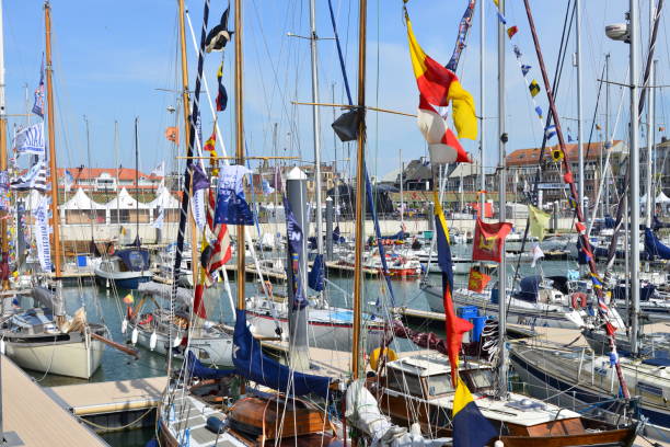 Blankenberge spring holiday tourism harbor festival Blankenberge, West-Flanders, Belgium - May 20, 2023: at this event yachting club owners decorate their boats with colorful pennant flags on the mast ships in the marina pennant bannerfish photos stock pictures, royalty-free photos & images