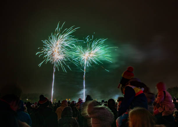 Crowds Watching The Annual Bicester Round Table Fireworks Display Crowds watching the annual Bicester Round Table fireworks display at Pingle Field, Bicester, Oxfordshire on bonfire night. long exposure winter crowd blurred motion stock pictures, royalty-free photos & images