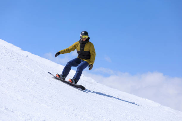 istock Snowboarding   Young man  snowboarder  on the mountain ski slope 1492539446