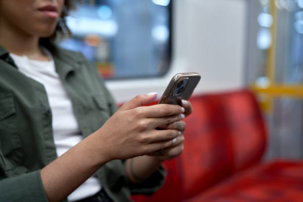 istock Unrecognizable woman traveling by underground and browsing a mobile phone 1492542542