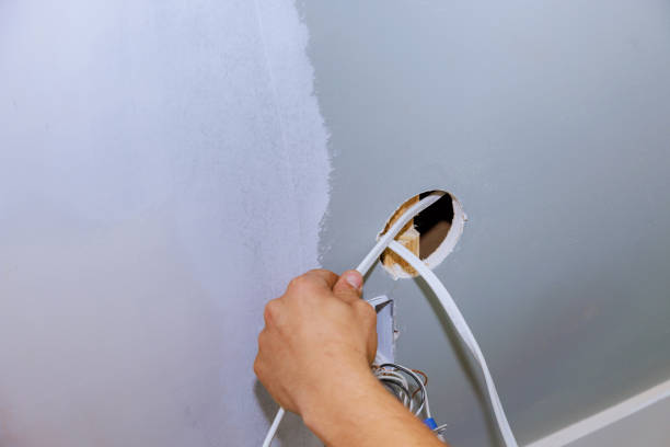 istock During the construction of a new house, a worker is installing a new current socket in a safe manner 1492544004