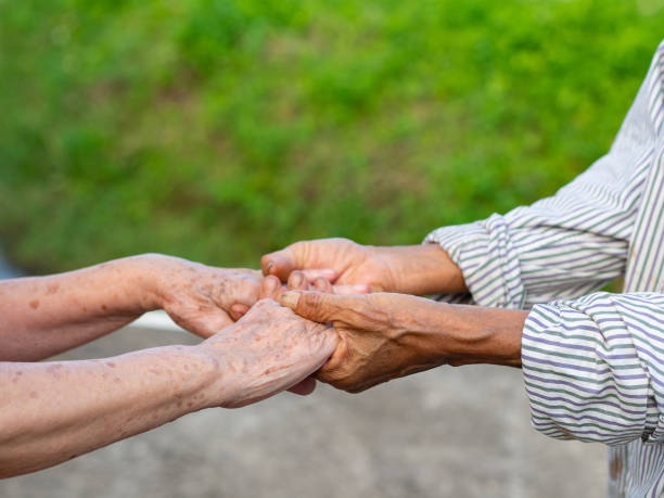istock Close-up of shaking hands between senior women. 1492544428