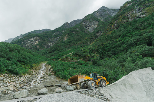 Excavator   working on site in  Norwegian mountains