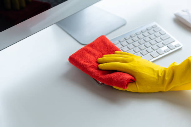 istock Person cleaning room, cleaning worker is using cloth to wipe computer keyboard in company office room. Cleaning staff. Concept of cleanliness in the organization. 1492546059